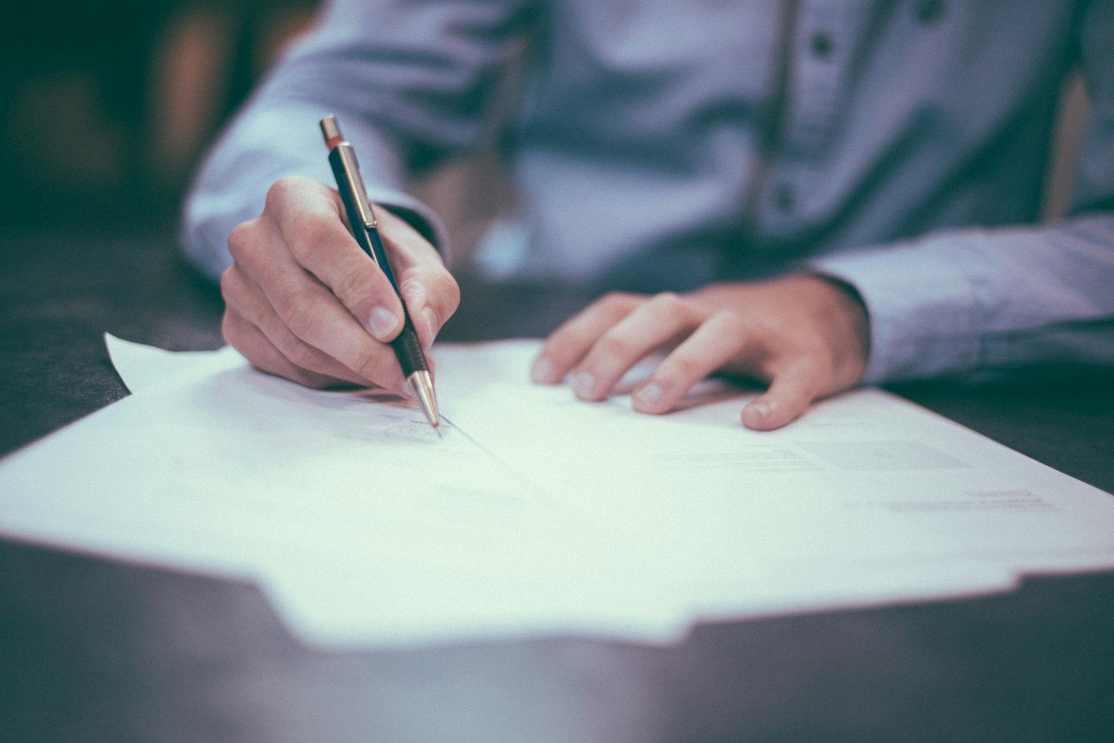 Person signing a contract document